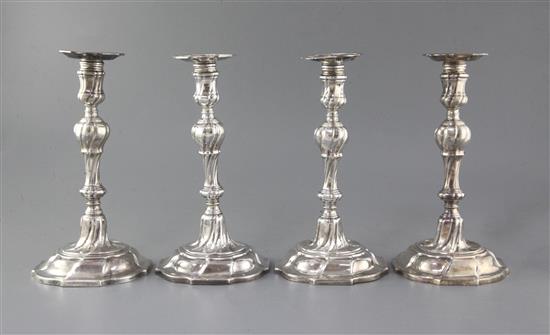 A matched set of four late 18th century silver candlesticks, engraved with the Heneage family crest,